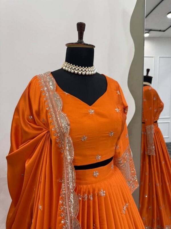 A stunning Satin Silk Lehenga Set with rich embroidery, sequins, and a cutwork border dupatta. Designed for elegance with a voluminous cancan and detailed choli.