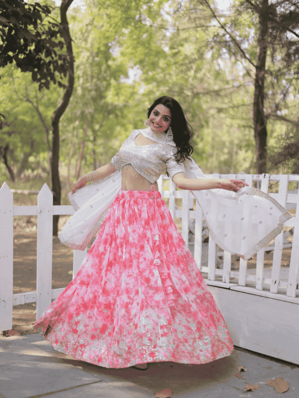 A stunning digital printed georgette lehenga featuring sequins and thread embroidery, paired with an embroidered faux blooming dupatta and an unstitched blouse.