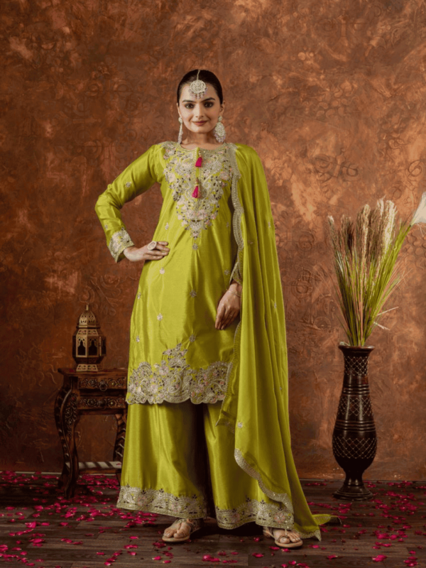 A luxurious designer Chinon Silk party wear set featuring a finely embroidered top, palazzo with an elastic waistband, and a dupatta with intricate cutwork. The soft micro cotton lining ensures all-day comfort, while the 3mm sequence and dori embroidery add a rich and elegant touch, making it perfect for special occasions.