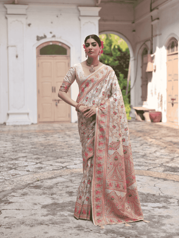 Exquisite silk saree with vibrant Kashmiri jal weaving, a grand zari and Meena work pallu, stylish tassels, and a contrast blouse piece.