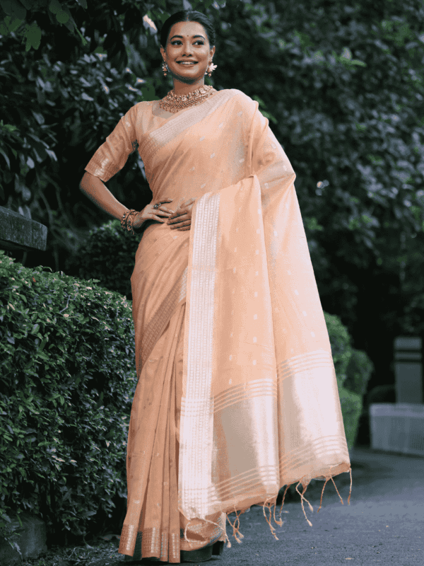 A graceful Maheshwari tissue silk saree adorned with zari woven butties, a rich zari pallu, and a beautifully designed border with fancy tassels. Includes a matching blouse piece.