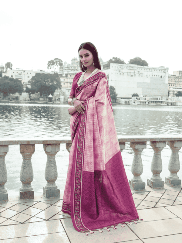 Soft silk saree with a floral-printed contrast border, an intricately woven zari pallu, and an elegant all-over zari weaving pattern, paired with a matching contrast blouse.