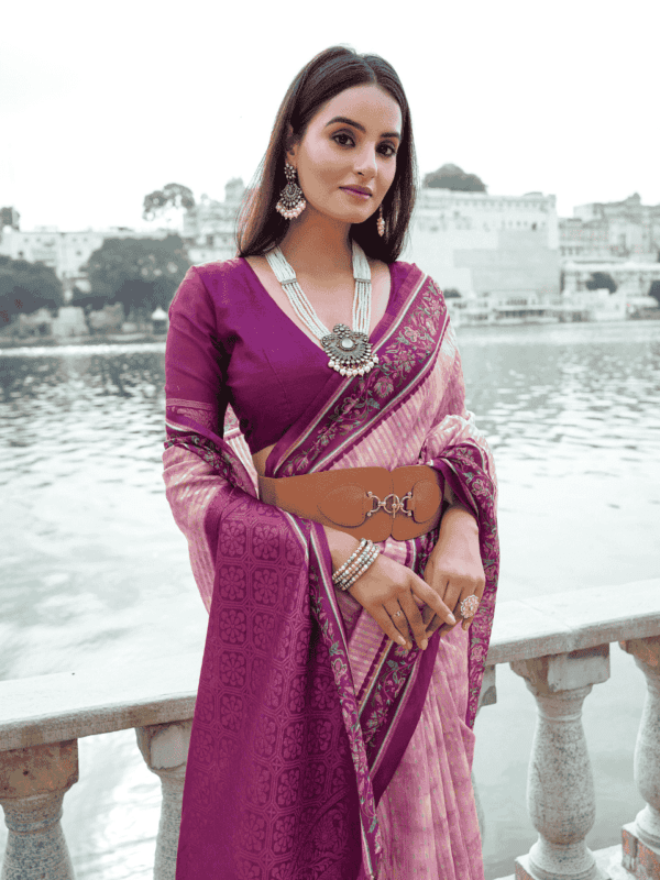 Soft silk saree with a floral-printed contrast border, an intricately woven zari pallu, and an elegant all-over zari weaving pattern, paired with a matching contrast blouse.