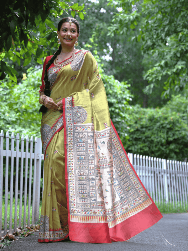 Soft Tussar Silk Saree with Madhubani prints, a Warli-printed contrast pallu, a unique contrast border, and a matching contrast blouse piece.