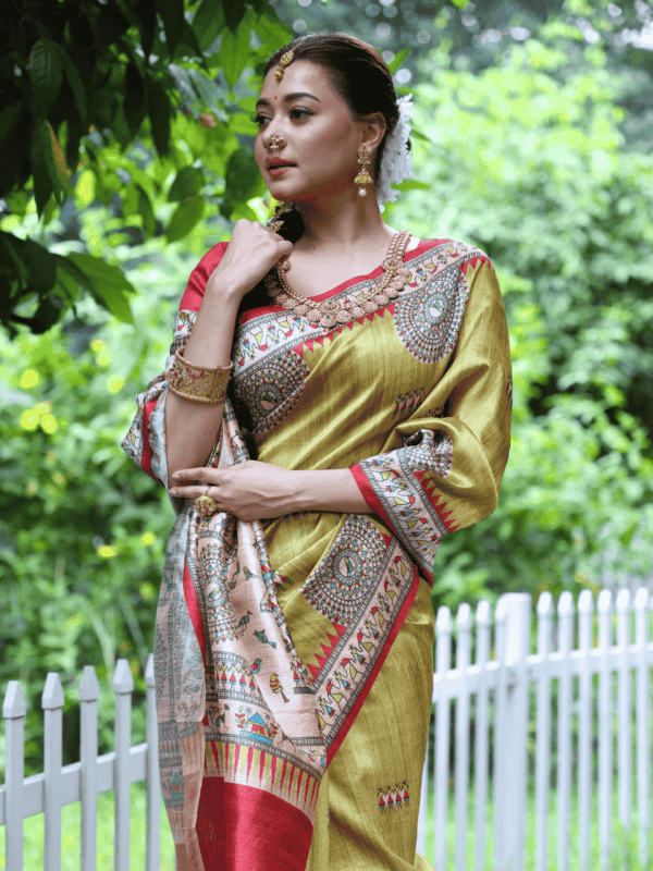 Soft Tussar Silk Saree with Madhubani prints, a Warli-printed contrast pallu, a unique contrast border, and a matching contrast blouse piece.