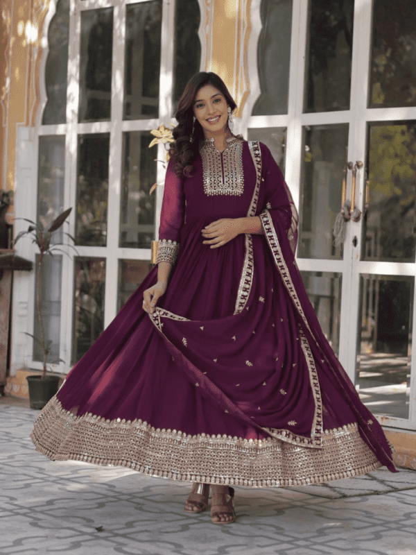 A stunning faux blooming georgette gown with intricate sequins embroidery, featuring a 3.5-meter flair, quarter sleeves, and a fancy neckline, paired with an elegantly embroidered lace-bordered dupatta.