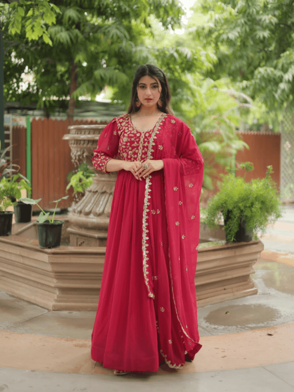 A breathtaking pink faux blooming georgette gown with puff sleeves, intricate sequins embroidery, and a round neckline, complemented by a stunning Arco-cut embroidered dupatta.