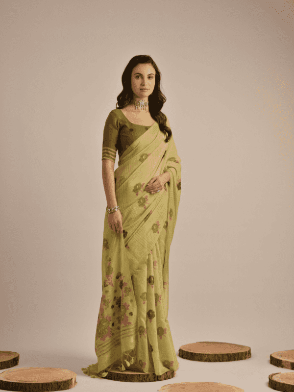 Traditional Muga Cotton saree with vibrant floral motif weaving, elegant buttas, and detailed lining, complemented by a contrast blouse and tassels.