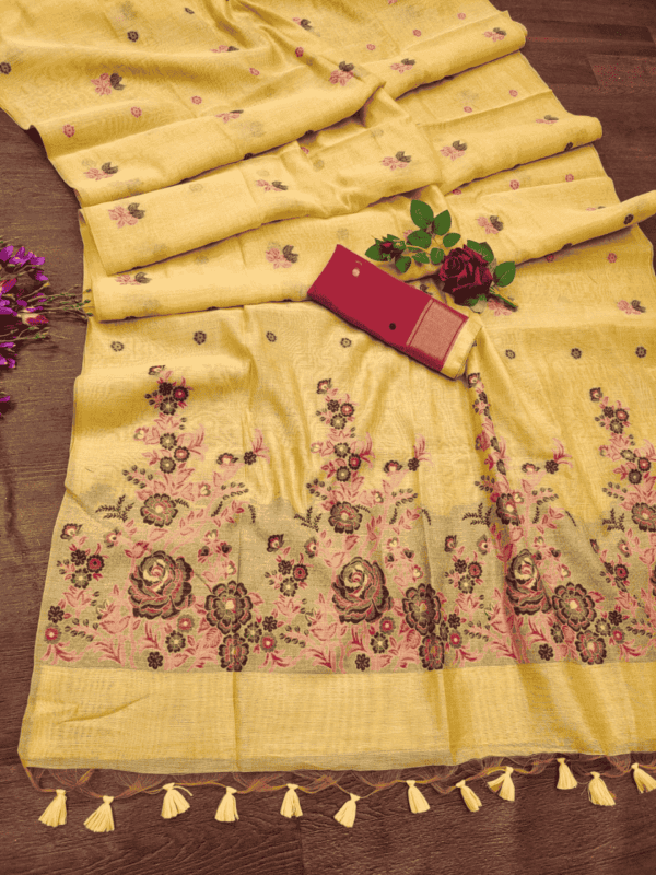 Luxurious cotton saree with intricate floral weaving, vibrant resham pallu, stylish tassels, and a complementing contrast blouse piece.