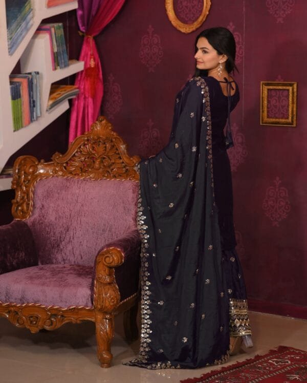 An elegant Chinon suit with intricate sequence embroidery, paired with a fully stitched sharara and a matching 2.2-meter dupatta, ideal for festive wear.