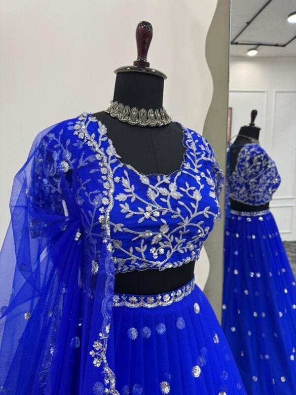 A heavy boutique collection lehenga with faux georgette fabric, thread and sequence work, featuring a semi-stitched lehenga, unstitched choli, and butterfly net dupatta.