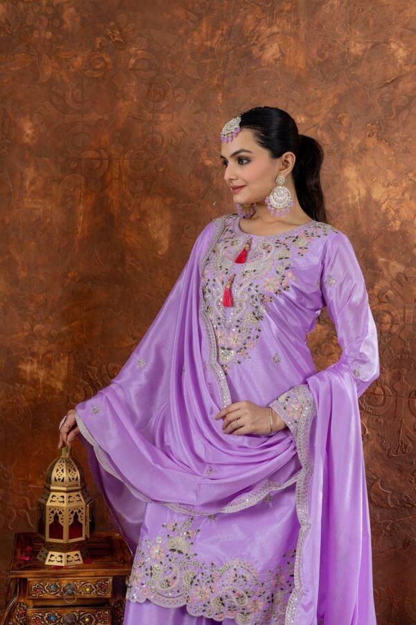 A luxurious designer Chinon Silk Party Wear Set featuring a beautifully embroidered top, palazzo with elastic waistband, and a dupatta with cutwork embroidery. The soft micro cotton lining ensures comfort, while the elegant sequence and dori work add a touch of sophistication, making it a perfect outfit for festive and party occasions.