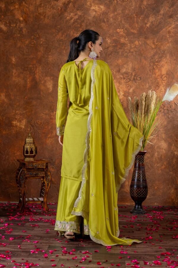 A luxurious designer Chinon Silk party wear set featuring a finely embroidered top, palazzo with an elastic waistband, and a dupatta with intricate cutwork. The soft micro cotton lining ensures all-day comfort, while the 3mm sequence and dori embroidery add a rich and elegant touch, making it perfect for special occasions.