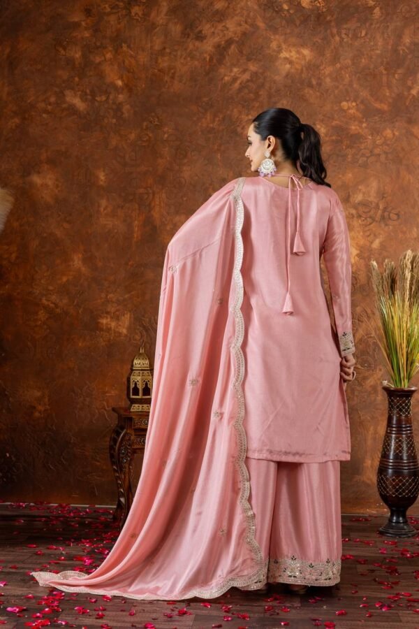 A premium Chinon Silk party wear set featuring a finely embroidered top, palazzo with an adjustable waistband, and a dupatta with intricate cutwork detailing. The soft micro cotton lining ensures comfort, while the 3mm sequence and dori embroidery give a rich, elegant appeal—perfect for festive celebrations and special occasions.