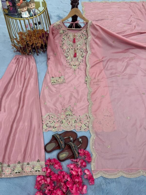 A premium Chinon Silk party wear set featuring a finely embroidered top, palazzo with an adjustable waistband, and a dupatta with intricate cutwork detailing. The soft micro cotton lining ensures comfort, while the 3mm sequence and dori embroidery give a rich, elegant appeal—perfect for festive celebrations and special occasions.