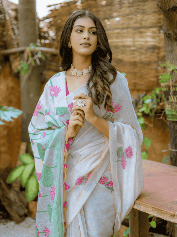 Exquisite soft silk saree with detailed floral weaving, a traditional Pichwai-style pallu, elegant tassels, and a stylish contrast blouse piece.