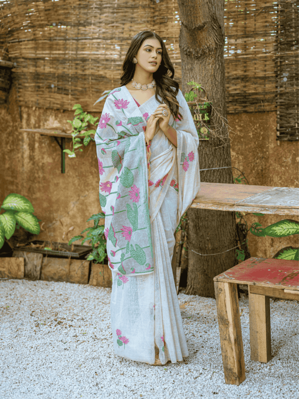 Exquisite soft silk saree with detailed floral weaving, a traditional Pichwai-style pallu, elegant tassels, and a stylish contrast blouse piece.