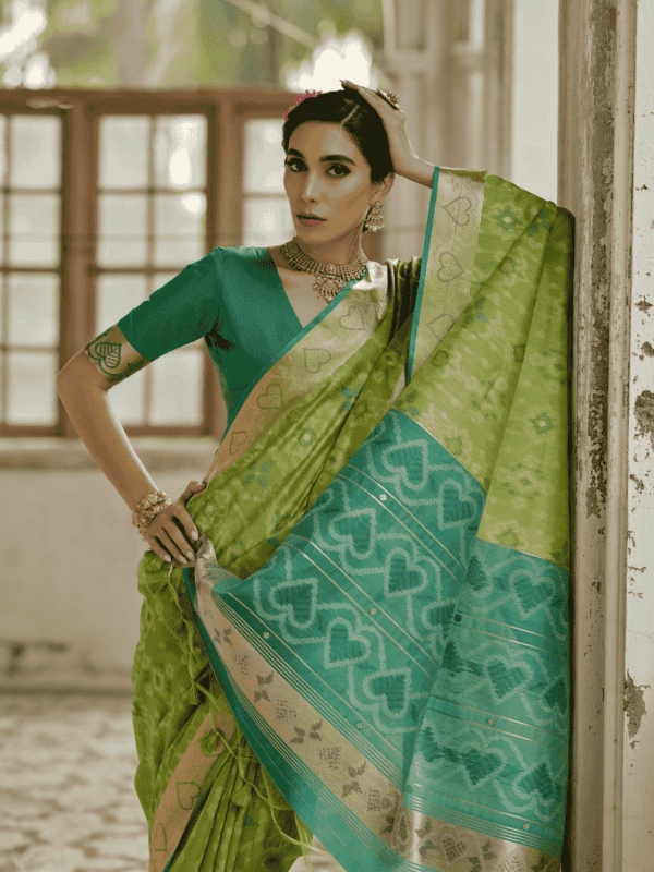 A beautifully woven Soft Desi Raw Silk saree with Pochampally Ikkat design, resham jal weaving, a zari border, and a classic traditional pallu with fancy tassels. Includes a contrast blouse piece.