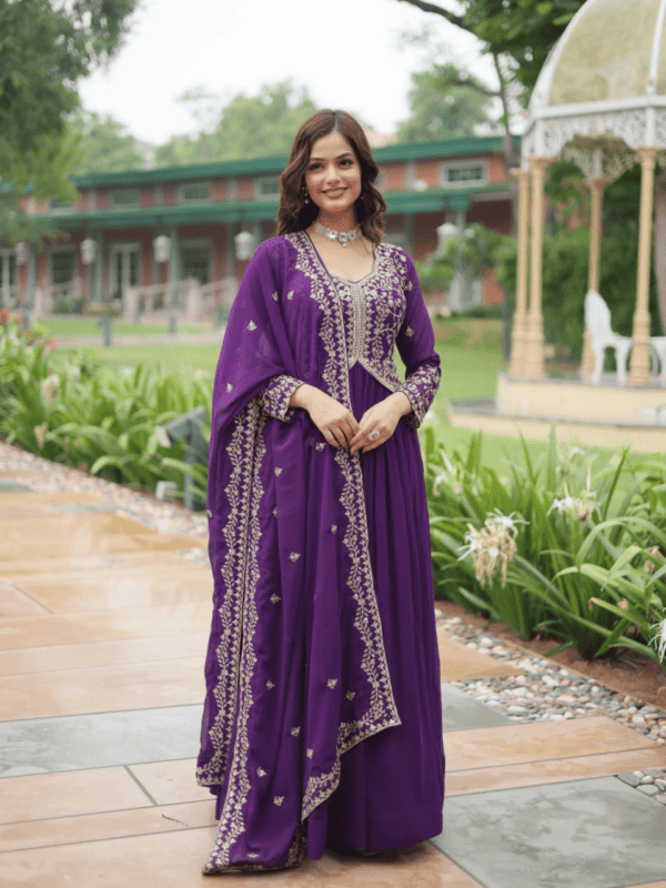 A stunning faux blooming gown with sequins and zari embroidery, paired with a faux georgette dupatta featuring a rich embroidered lace border. Available in Red and Purple.