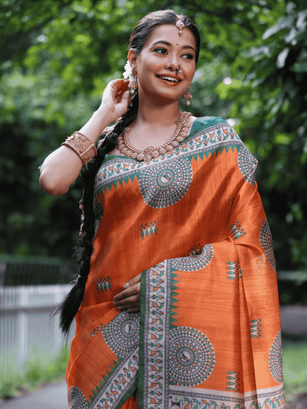 Soft Tussar Silk Saree with Madhubani prints, a Warli-printed contrast pallu, a unique contrast border, and a matching contrast blouse piece.