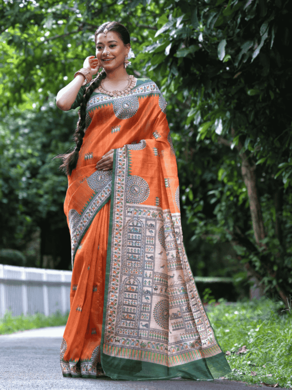 Soft Tussar Silk Saree with Madhubani prints, a Warli-printed contrast pallu, a unique contrast border, and a matching contrast blouse piece.